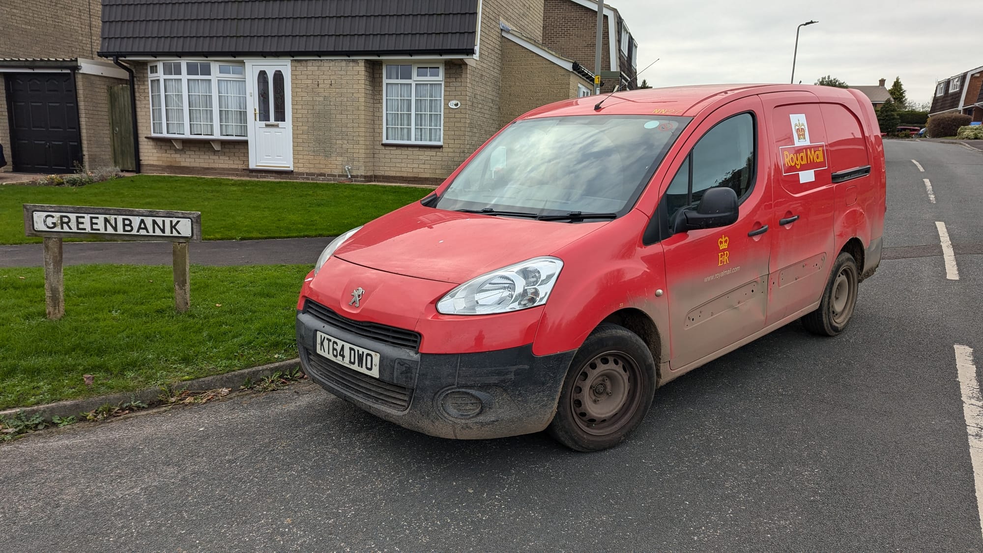 Red Royal Mail post van, parked on a Northallerton street